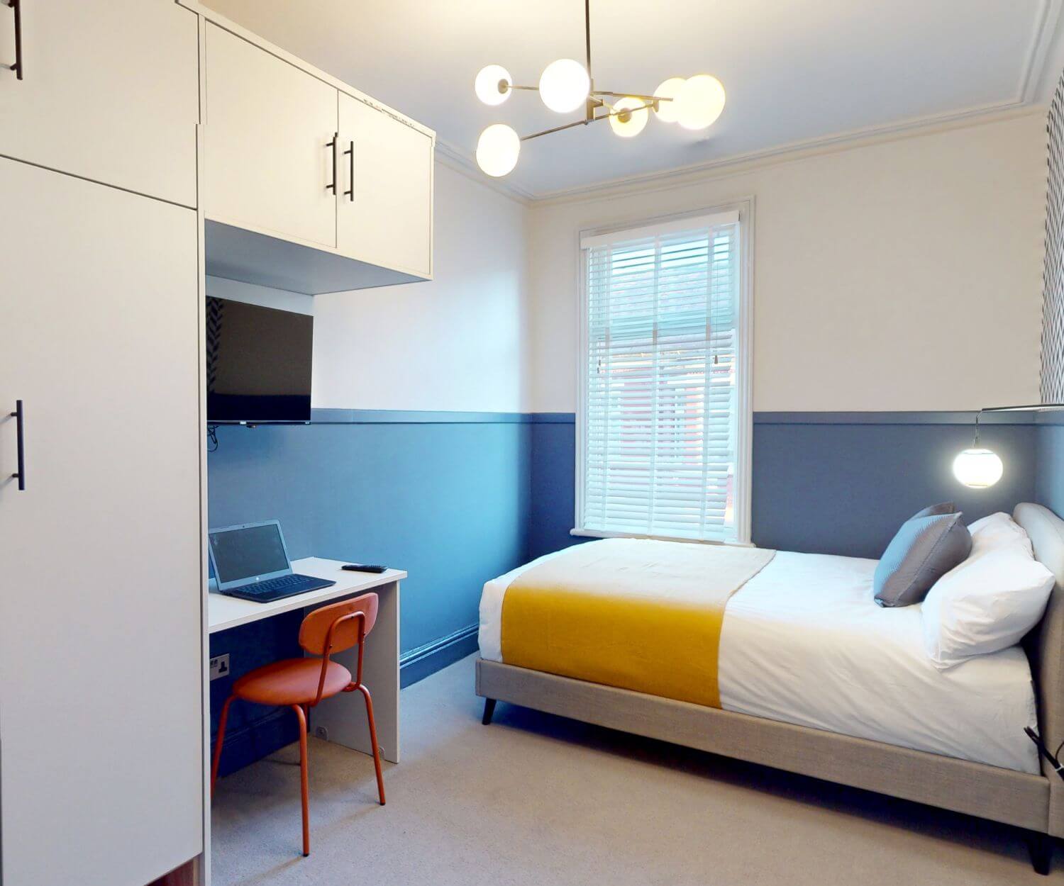 Spacious double bedroom with a double bed, desk & chair, wardrobe and smart TV