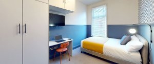 Spacious bedroom in a house share with a large bed and desk for working