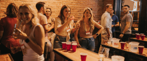 Young professionals enjoying beer pong at Liverpool bar - best nightlife Liverpool offers for group entertainment and after-work drinks